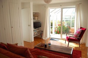 Living room with view through to conservatory