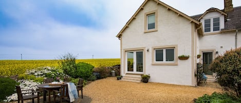 the front garden leading through the patio doors to the dining area