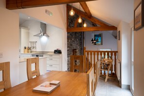 a seperate dining area off kitchen with view to snug room with log burner 