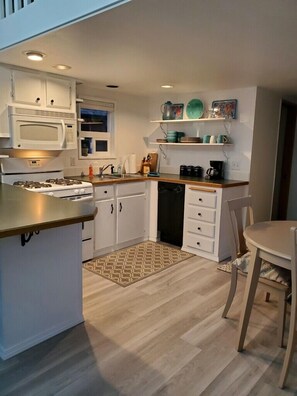 Kitchen after dark. Light off over the table.
