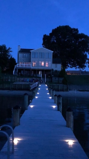 View of houose from pier lite up at night