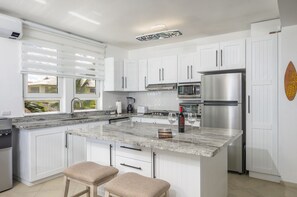 Kitchen is Modern & Remodeled. A Large Granite Island is great for eating & prep