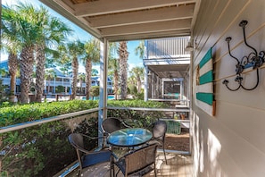 The screened entrance porch offers a view of the largest pool & hot tub.