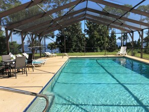 Large screened pool overlooking bay