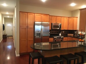 Kitchen and view down the hallway toward the master bedroom and back entrance