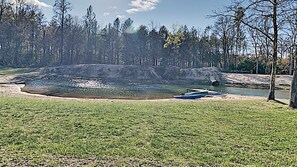 Private Sandy bottom swimming pond with splash pad matt