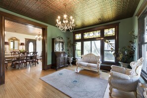 Original tin ceiling and crystal chandelier on the first floor of the mansion.
