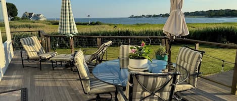 Raised deck dining and lounging set; additional dining chairs not pictured