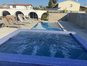 Pool deck with lounge chairs and umbrellas 