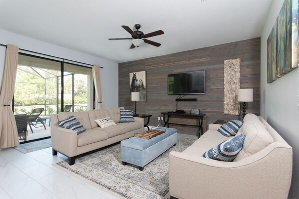 Living room with sliders out to screened in pool deck