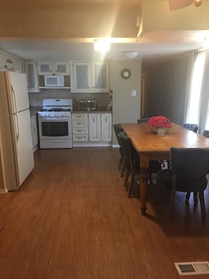 Spacious kitchen with large farm table.