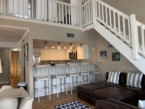 The kitchen overlooks the living room and 5 can sit comfortably at the bar.