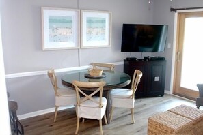 Dining area. Cabinet under the 50 inch television serves as a pantry.