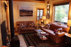 Cozy Living room with wood burning efficient stove/fireplace.