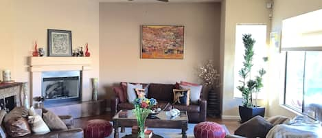 Living room with fireplace and lots of natural light.