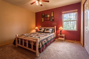 This first floor bedroom has a rustic queen-sized rustic bed.