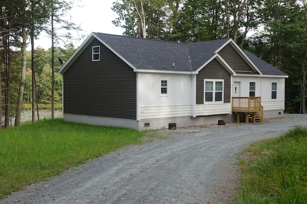 house and pond behind it