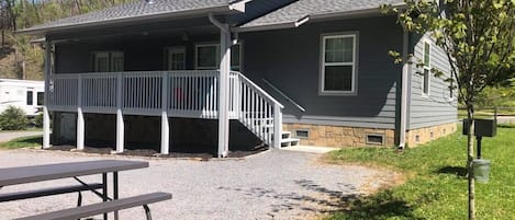 Front of house with grill and picnic table