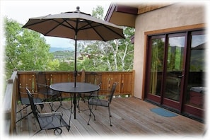 Large deck with seating, with gas grill, and views of the Yampa Valley