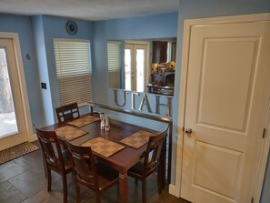kitchen table seats up to six people. Stairway leading to the downstairs. 