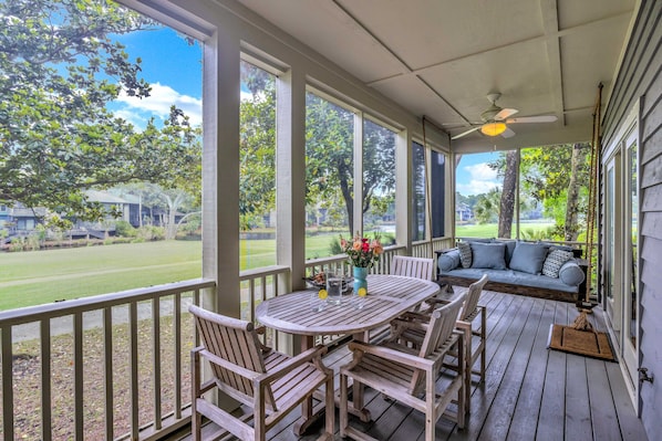 Amazing screen porch to watch the golfers pass by!