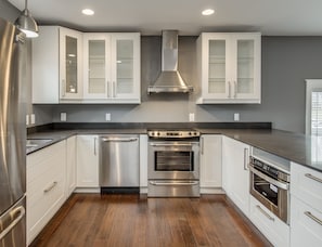 The kitchen on the main level has dinnerware, glasses, silverware and cookware.