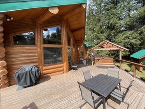 Enjoy the spacious deck with hot tub, dining table, and grill.