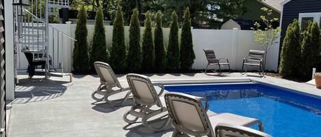 Pool area with spiral staircase too rooftop sundeck