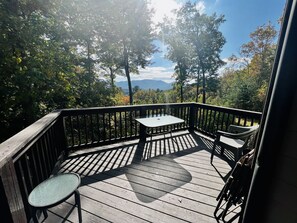 Small deck with table and chairs. View of the mountains. 