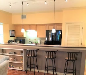 Kitchen with large counter and three seat snack bar