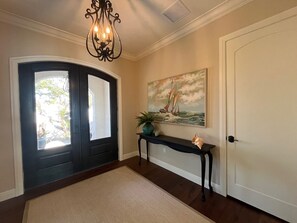 At the top of the stairs, you will enter into the foyer.  Coat clothes on right.