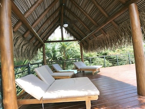 Relax in the shade under the large palapa on the pool deck.