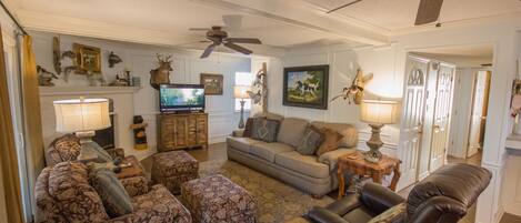 Family room with large sofa, two chairs with ottomans and a lazy boy recliner