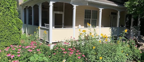 Our Lakeside cottage in full bloom, view of our front porch and screened porch