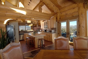 View of the kitchen entry and second door onto the deck