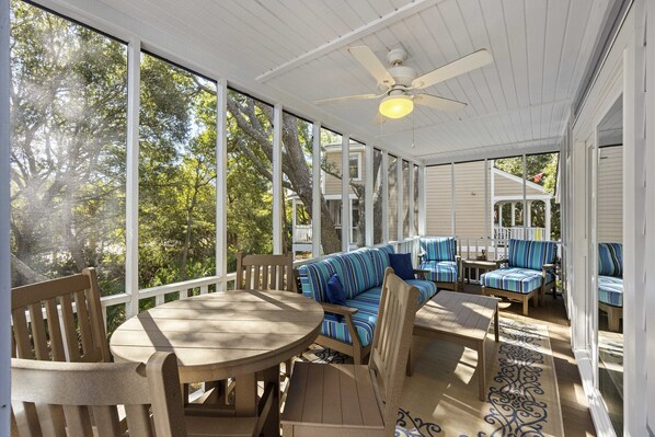 Lovely screened porch with furniture to lounge in!