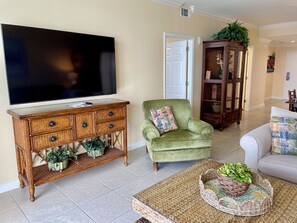 Living room has 65 inch flat screen TV