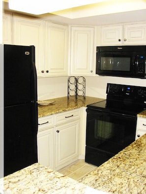 New kitchen w/ granite countertops and all the cooking utensils you'll need.