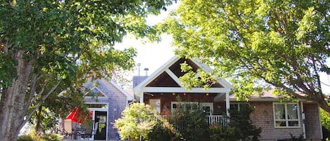 The side view of house with ample decks and seating areas.