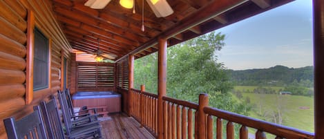 Main Deck with plenty of rocking chairs and hot tub