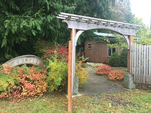 Walk through this arch to the front porch of the Cottage.