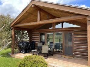 Front porch with grill and seating for four