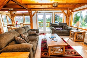 Living room with patio and dining area in background.