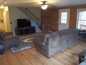 Main floor living room has lots of room to relax and great views out the windows