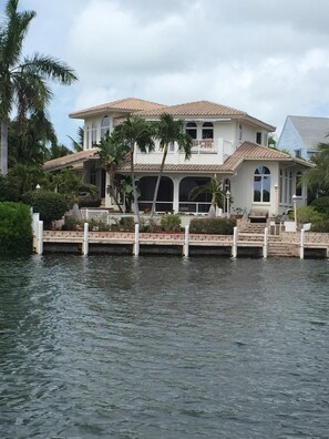 View of the back of the house and screen porch form the water