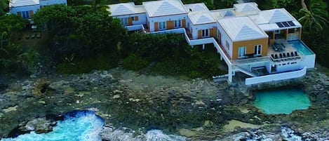 Aerial view of the main villa and cottage located on a large private lot