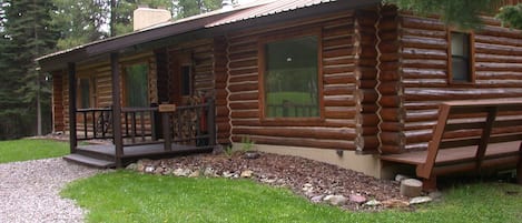As you arrive at the Elk Antler Cabin, a log house with 3000 sq ft of space.