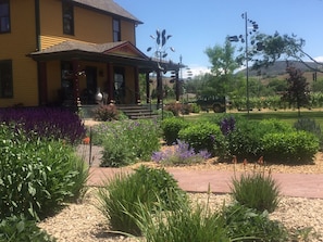 The perennial garden and wind sculptures in the front yard of the farmhouse 