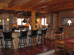 Gourmet Kitchen with built in appliances, granite counter tops, 2 sinks, bar
