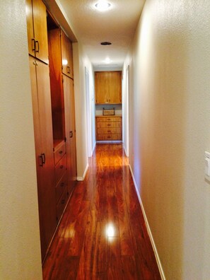 Hallway leading to bedrooms & bathrooms. Cabinets filled with games, linens, etc